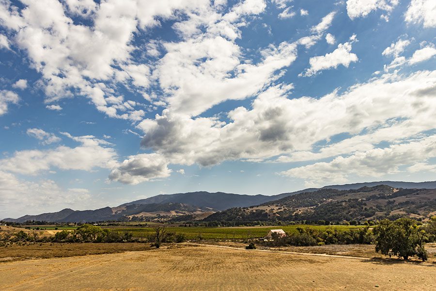 Orland CA - Scenic View of a Farm Landscape with Mountains in the Background in Orland California with a Cloudy Sky